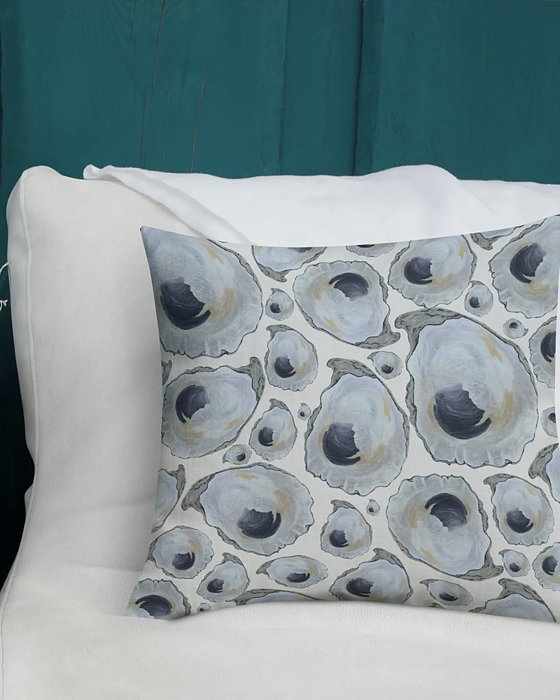 Coastal oyster shell print pillow on off-white background